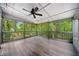 Covered screened-in porch with ceiling fan and wooded views at 5535 Dorsett Shoals Rd, Douglasville, GA 30135