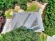 Birds eye view of a home featuring a gray roof surrounded by lush trees and landscaping at 662 Shady Willow Ln, Loganville, GA 30052