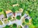 Aerial view of a residential area featuring lush greenery, homes, and quiet cul-de-sac street at 662 Shady Willow Ln, Loganville, GA 30052