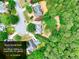 Aerial view showing property boundaries, mature trees, lush surroundings, homes in a serene neighborhood setting at 662 Shady Willow Ln, Loganville, GA 30052