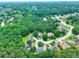 Wide aerial shot showcasing a neighborhood with mature trees, manicured lawns and winding roads in a suburban setting at 662 Shady Willow Ln, Loganville, GA 30052
