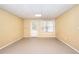 Finished basement area featuring tile floors, neutral paint, and a door and window to the outside at 662 Shady Willow Ln, Loganville, GA 30052