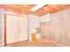 Unfinished basement with walkout door and exposed ceiling at 662 Shady Willow Ln, Loganville, GA 30052