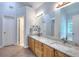 Bathroom featuring a double sink with granite countertops and updated lighting at 662 Shady Willow Ln, Loganville, GA 30052