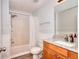 Well-lit bathroom featuring a shower-tub combo, granite vanity, and modern fixtures at 662 Shady Willow Ln, Loganville, GA 30052