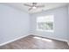 Bright bedroom with hardwood floors, ceiling fan, and large window offering ample natural light at 662 Shady Willow Ln, Loganville, GA 30052