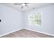 Charming bedroom with hardwood floors, ceiling fan, and large window bringing in natural light at 662 Shady Willow Ln, Loganville, GA 30052