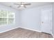 Inviting bedroom featuring hardwood floors, a window, and ceiling fan at 662 Shady Willow Ln, Loganville, GA 30052