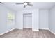 The spacious bedroom features a large closet, a window for natural light, and wood-look flooring at 662 Shady Willow Ln, Loganville, GA 30052