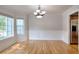 Elegant dining room with wainscoting, hardwood floors, and a modern chandelier at 662 Shady Willow Ln, Loganville, GA 30052