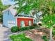 Exterior view of the house showing a well-manicured yard, blue siding, and a brick accent wall at 662 Shady Willow Ln, Loganville, GA 30052