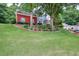 Two-story home with brick and siding exterior, a well-manicured lawn, and landscaped flower beds at 662 Shady Willow Ln, Loganville, GA 30052