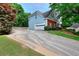 Exterior view of a home with a two-car garage and a long, wide driveway at 662 Shady Willow Ln, Loganville, GA 30052