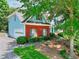 Side view of a blue and brick home with a white garage door and a well-manicured lawn at 662 Shady Willow Ln, Loganville, GA 30052