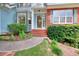 Inviting front entrance with brick steps, landscaped bushes, and a glass front door at 662 Shady Willow Ln, Loganville, GA 30052