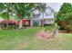 Charming two-story home featuring lush green lawn, landscaped garden beds, and trees at 662 Shady Willow Ln, Loganville, GA 30052