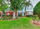 Charming two-story home with a beautifully landscaped front yard and vibrant flower beds at 662 Shady Willow Ln, Loganville, GA 30052