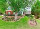 Charming two-story home with a well-manicured lawn, mature trees, and brick accents at 662 Shady Willow Ln, Loganville, GA 30052