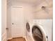 A laundry room with a washer and dryer, shelving, and tile flooring at 662 Shady Willow Ln, Loganville, GA 30052