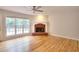 Spacious living room with hardwood floors, a brick fireplace, and natural light at 662 Shady Willow Ln, Loganville, GA 30052