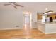 Open-concept living room with hardwood floors flowing into a kitchen with granite countertops at 662 Shady Willow Ln, Loganville, GA 30052