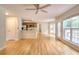 Bright living room with hardwood floors and an open layout leading to the kitchen at 662 Shady Willow Ln, Loganville, GA 30052