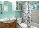 Bathroom features a clean white sink, toilet, and tub with a stylish patterned shower curtain at 118 Lucia Dr, Smyrna, GA 30082