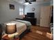 Bedroom features hardwood floors, television, ceiling fan, and a comfortable bed at 118 Lucia Dr, Smyrna, GA 30082