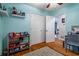 Bedroom featuring storage and toys with hardwood floors and open door to dining room at 118 Lucia Dr, Smyrna, GA 30082