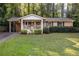 Charming brick home featuring a welcoming front porch and well-maintained lawn at 118 Lucia Dr, Smyrna, GA 30082