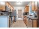 Galley kitchen featuring modern stainless steel appliances and a tile backsplash at 118 Lucia Dr, Smyrna, GA 30082