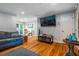 Comfortable living room with a large TV and hardwood floors perfect for entertaining at 118 Lucia Dr, Smyrna, GA 30082