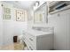 Bathroom with decorative white paneled walls, tiled floors, modern vanity, and shelving at 1691 Whitlock Rd, Marietta, GA 30066