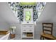 Bright bathroom featuring floral wallpaper and black and white floor tiles at 1691 Whitlock Rd, Marietta, GA 30066