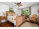 Bedroom with a wood bed frame, colorful quilt, wood floors, and natural light at 1691 Whitlock Rd, Marietta, GA 30066