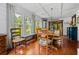 Bright dining room with wood floors, coffered ceiling, large windows overlooking the yard, and rustic wood furniture at 1691 Whitlock Rd, Marietta, GA 30066