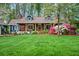 Charming single-story home featuring a well-manicured lawn, blooming shrubs, and inviting curb appeal at 1691 Whitlock Rd, Marietta, GA 30066
