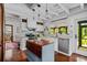 Farmhouse style kitchen with white cabinets, granite countertops, stainless steel appliances and wood floors at 1691 Whitlock Rd, Marietta, GA 30066