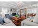 Cozy living room with exposed beam ceilings, fireplace, comfortable seating, and wood flooring at 1691 Whitlock Rd, Marietta, GA 30066