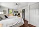 Bedroom features a white quilt bed, hardwood floors, natural lighting and a closet at 1691 Whitlock Rd, Marietta, GA 30066