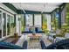 Cozy screened porch with porch swing, seating and backyard view at 1691 Whitlock Rd, Marietta, GA 30066