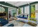 Inviting screened porch with swing, seating, and sliding glass door at 1691 Whitlock Rd, Marietta, GA 30066