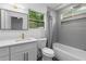 Bathroom featuring tiled shower, modern vanity, and natural light from the windows at 2001 Swazey Dr, Decatur, GA 30032