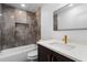 Bathroom features a shower and tub combination with brown tiling and gold hardware at 2001 Swazey Dr, Decatur, GA 30032