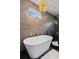 Bright bathroom featuring a freestanding tub and modern chandelier at 2001 Swazey Dr, Decatur, GA 30032