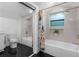 Bright bathroom featuring a tub/shower combo and vanity at 2001 Swazey Dr, Decatur, GA 30032