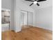 Bedroom featuring hardwood floors, mirrored closet doors, and ensuite bathroom access at 2001 Swazey Dr, Decatur, GA 30032