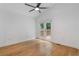 Bright bedroom with hardwood floors, ceiling fan, and French doors leading to a deck at 2001 Swazey Dr, Decatur, GA 30032