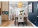 Cozy dining area featuring a wooden table with seating, stylish light fixture, and hardwood floors at 2001 Swazey Dr, Decatur, GA 30032