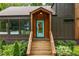 Inviting front entrance featuring a bright blue door and wooden steps, surrounded by lush landscaping at 2001 Swazey Dr, Decatur, GA 30032